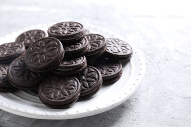 Photo of Many tasty sandwich cookies on light grey table