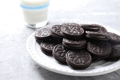 Photo of Many tasty sandwich cookies on light grey table