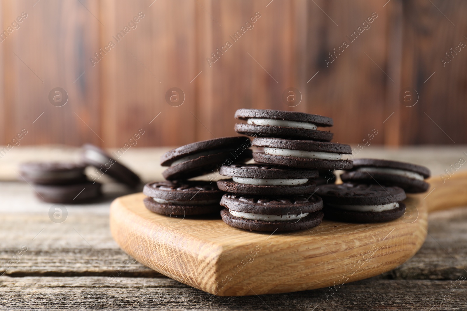 Photo of Many tasty sandwich cookies on wooden table