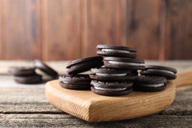 Photo of Many tasty sandwich cookies on wooden table