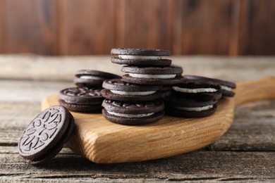 Photo of Many tasty sandwich cookies on wooden table