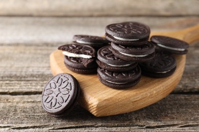 Photo of Many tasty sandwich cookies on wooden table