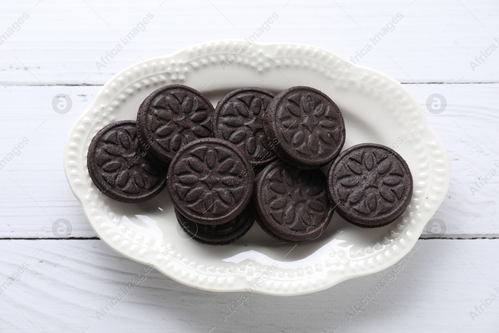 Photo of Many tasty sandwich cookies on white wooden table, top view