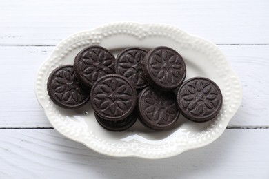 Photo of Many tasty sandwich cookies on white wooden table, top view