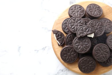 Photo of Tasty sandwich cookies on white marble table, top view. Space for text