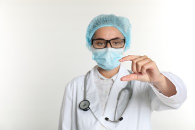 Photo of Doctor holding something on white background, selective focus