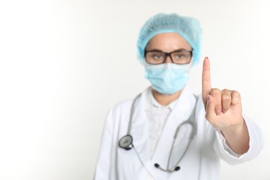 Photo of Doctor holding something on white background, selective focus. Space for text