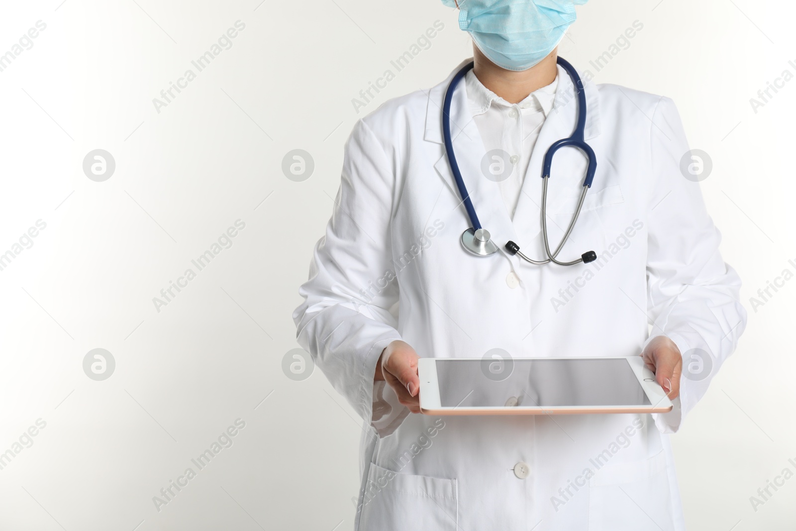 Photo of Doctor with tablet on white background, closeup view. Space for text