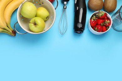 Photo of Hand blender kit and fresh fruits on light blue background, flat lay. Space for text