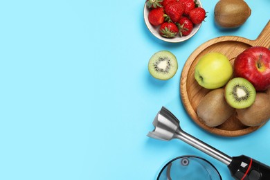 Photo of Hand blender kit and fresh fruits on light blue background, flat lay. Space for text