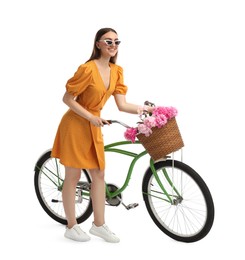 Photo of Smiling woman in sunglasses with bicycle and basket of peony flowers isolated on white