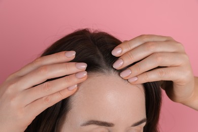 Photo of Woman with hair loss problem on pink background, closeup
