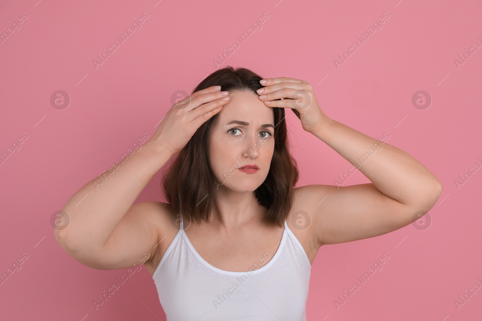 Photo of Woman with hair loss problem on pink background