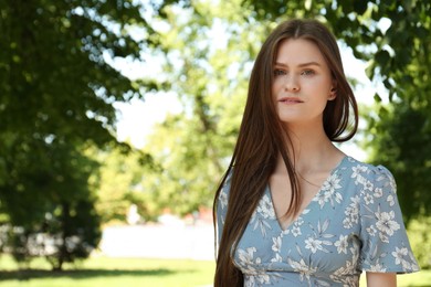 Photo of Portrait of beautiful woman in summer park, space for text