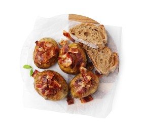 Photo of Delicious baked potatoes with bacon and bread isolated on white, top view