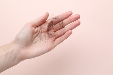 Photo of Woman with lost hair on light pink background, closeup