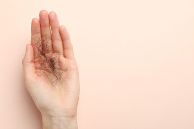 Photo of Woman with lost hair on light pink background, top view. Space for text