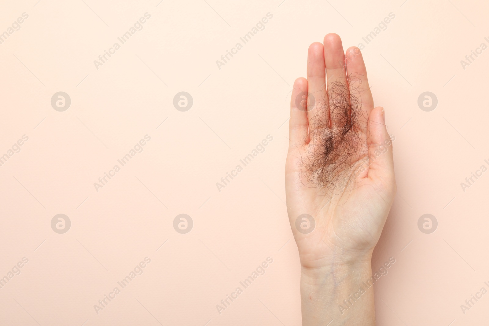 Photo of Woman with lost hair on light pink background, top view. Space for text