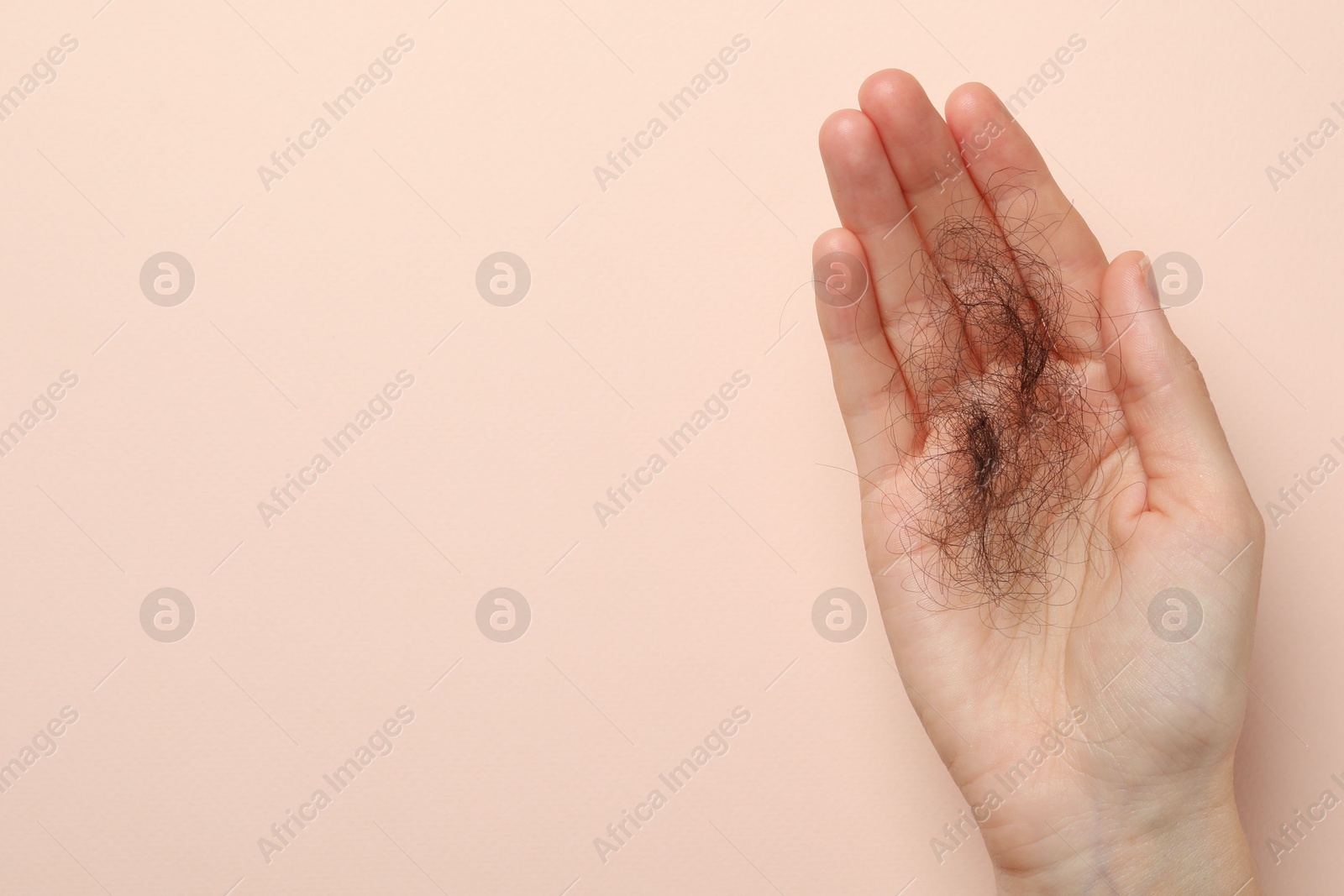 Photo of Woman with lost hair on light pink background, top view. Space for text