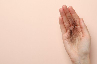 Photo of Woman with lost hair on light pink background, top view. Space for text