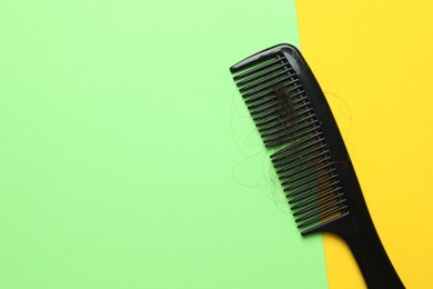 Photo of One comb with lost hair on color background, top view. Space for text