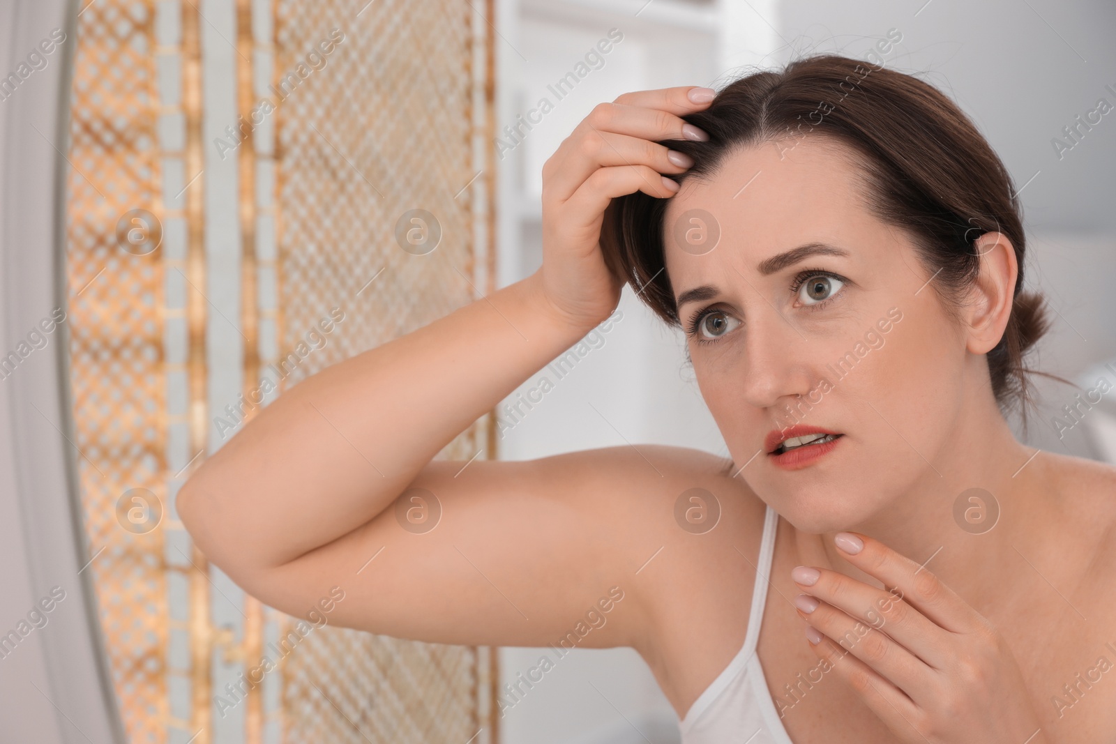 Photo of Woman with hair loss problem at home