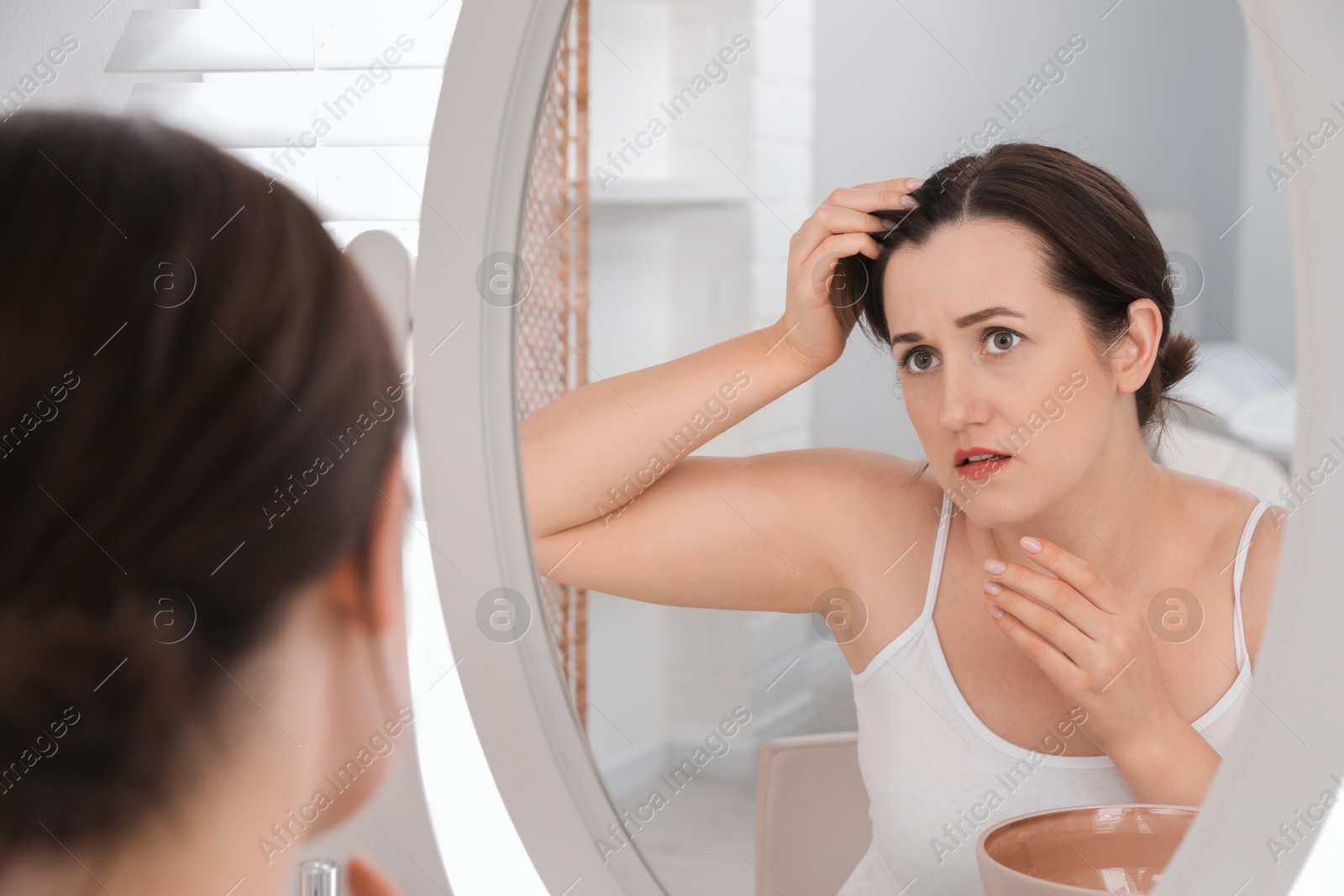 Photo of Woman with hair loss problem at home