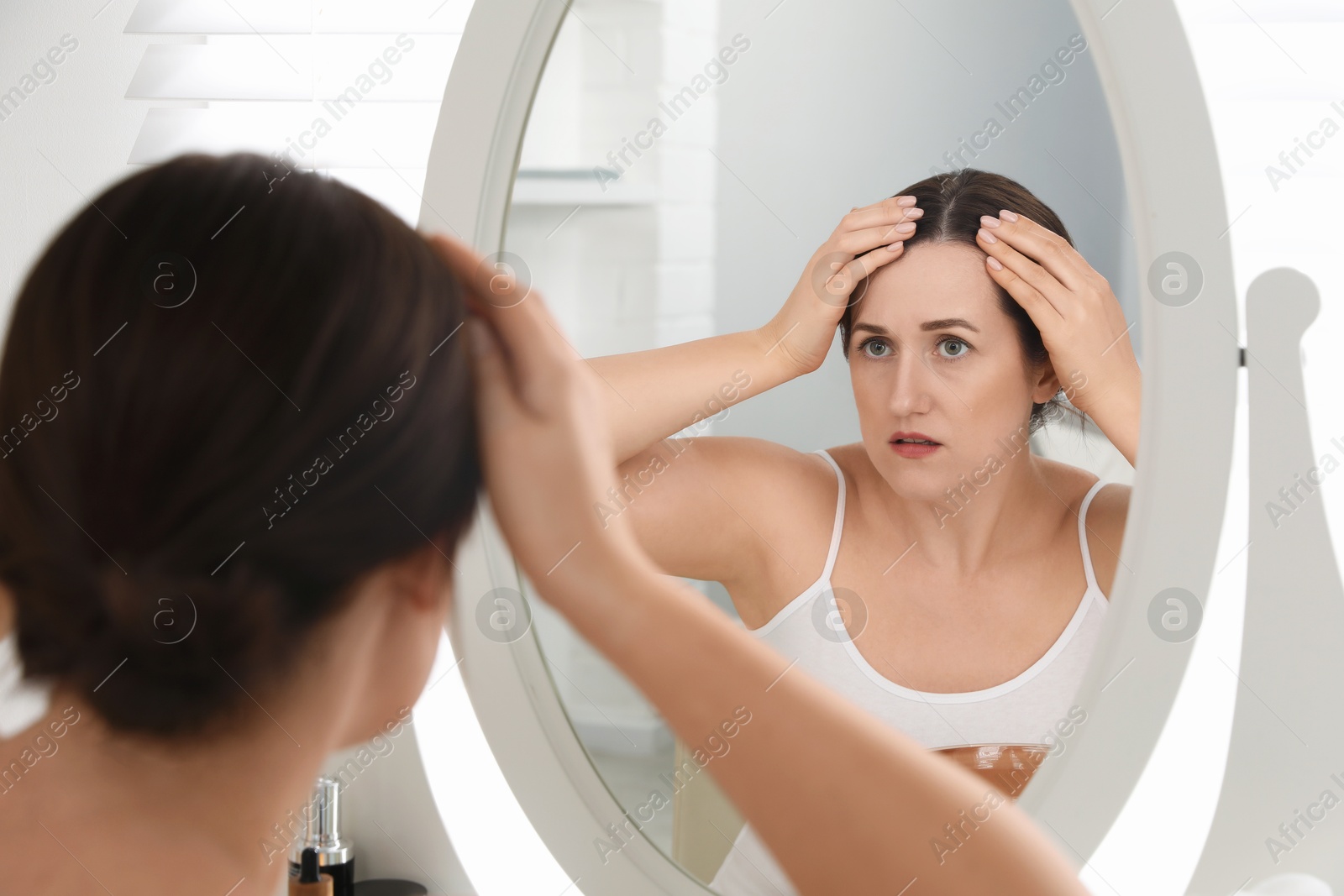 Photo of Woman with hair loss problem at home