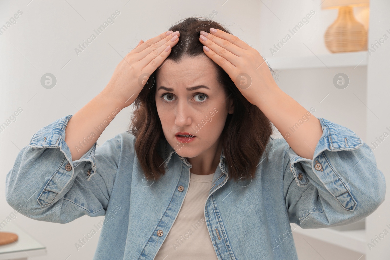 Photo of Woman with hair loss problem at home