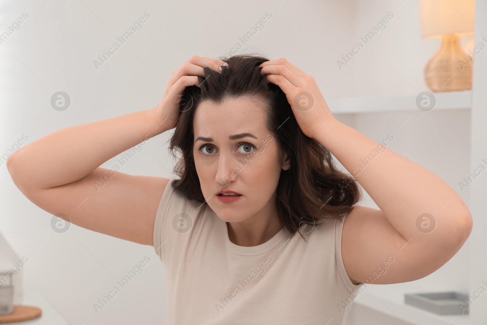 Photo of Woman with hair loss problem at home