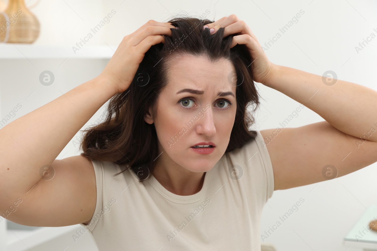 Photo of Woman with hair loss problem at home