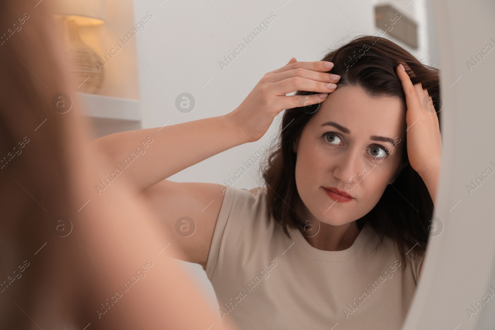 Photo of Woman with hair loss problem at home