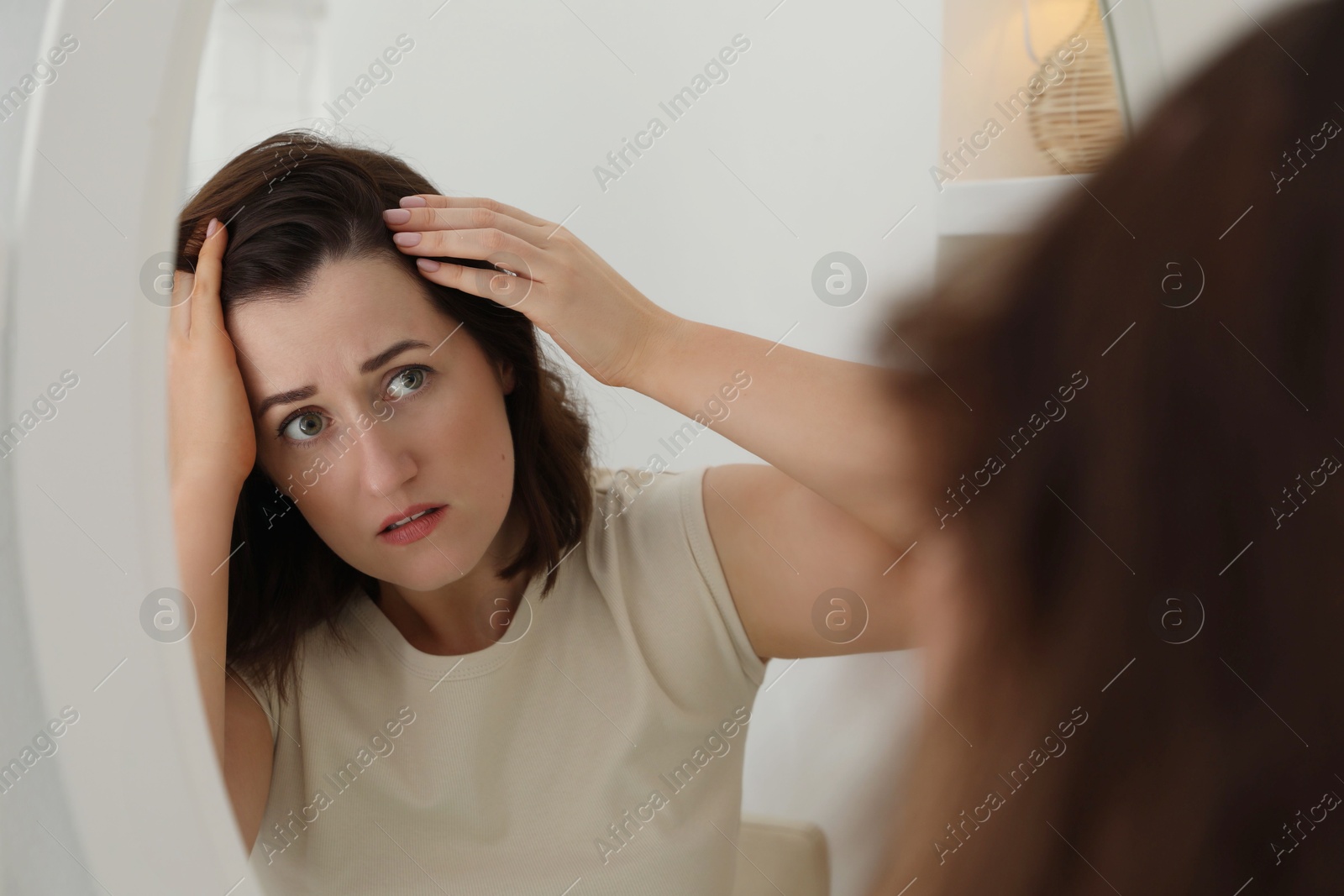 Photo of Woman with hair loss problem at home