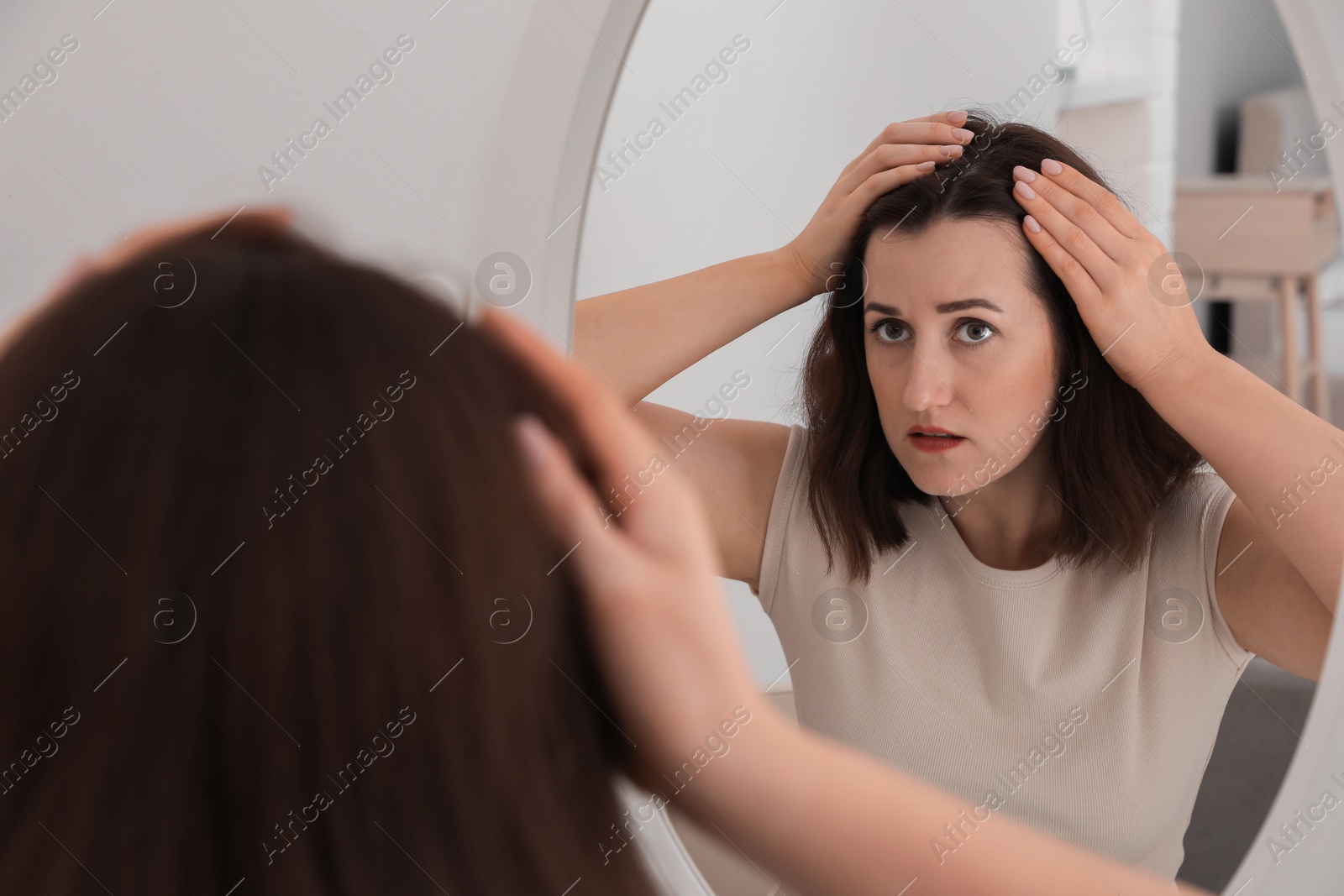 Photo of Woman with hair loss problem at home