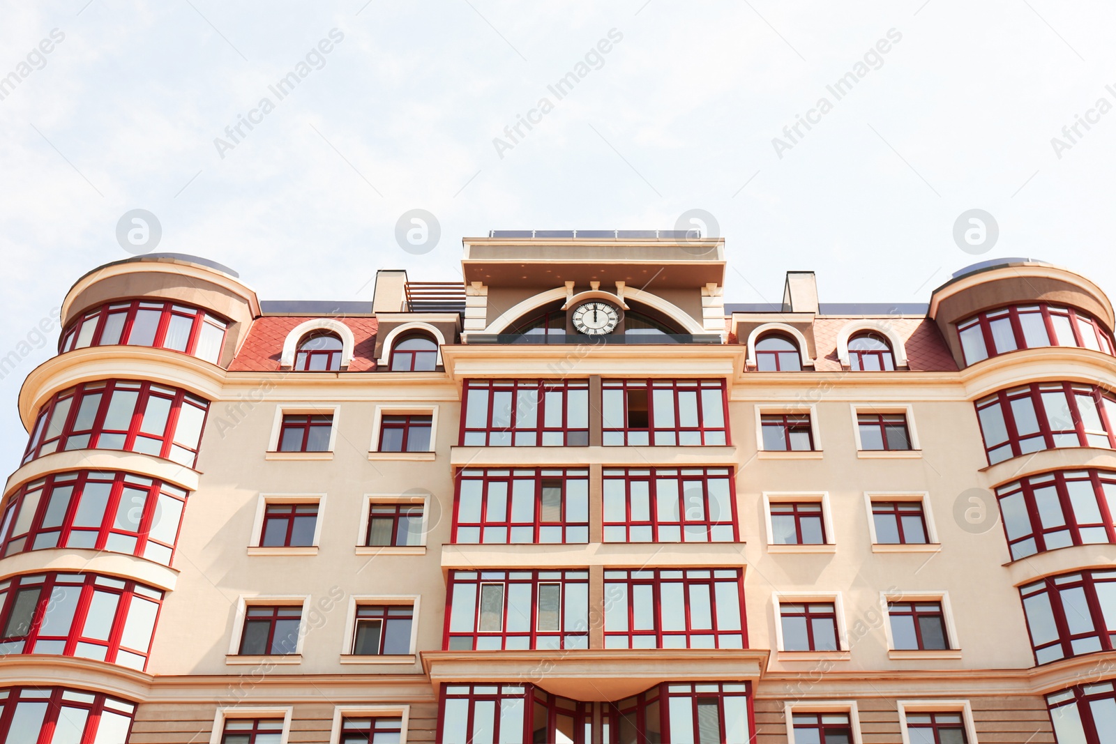 Photo of Modern building with glass windows outdoors, low angle view