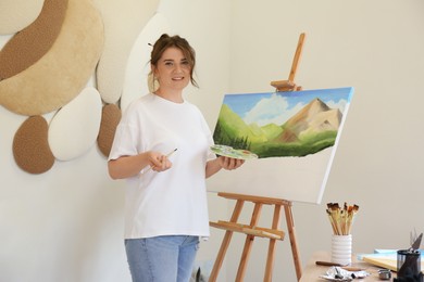 Photo of Woman drawing landscape with brush in studio