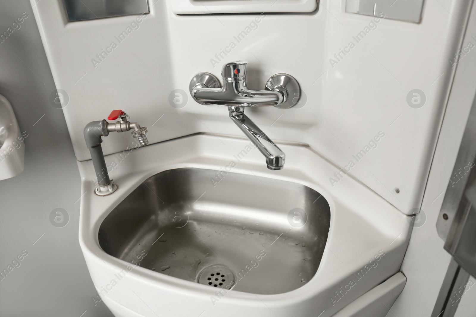 Photo of Stainless steel washbasin in train car restroom