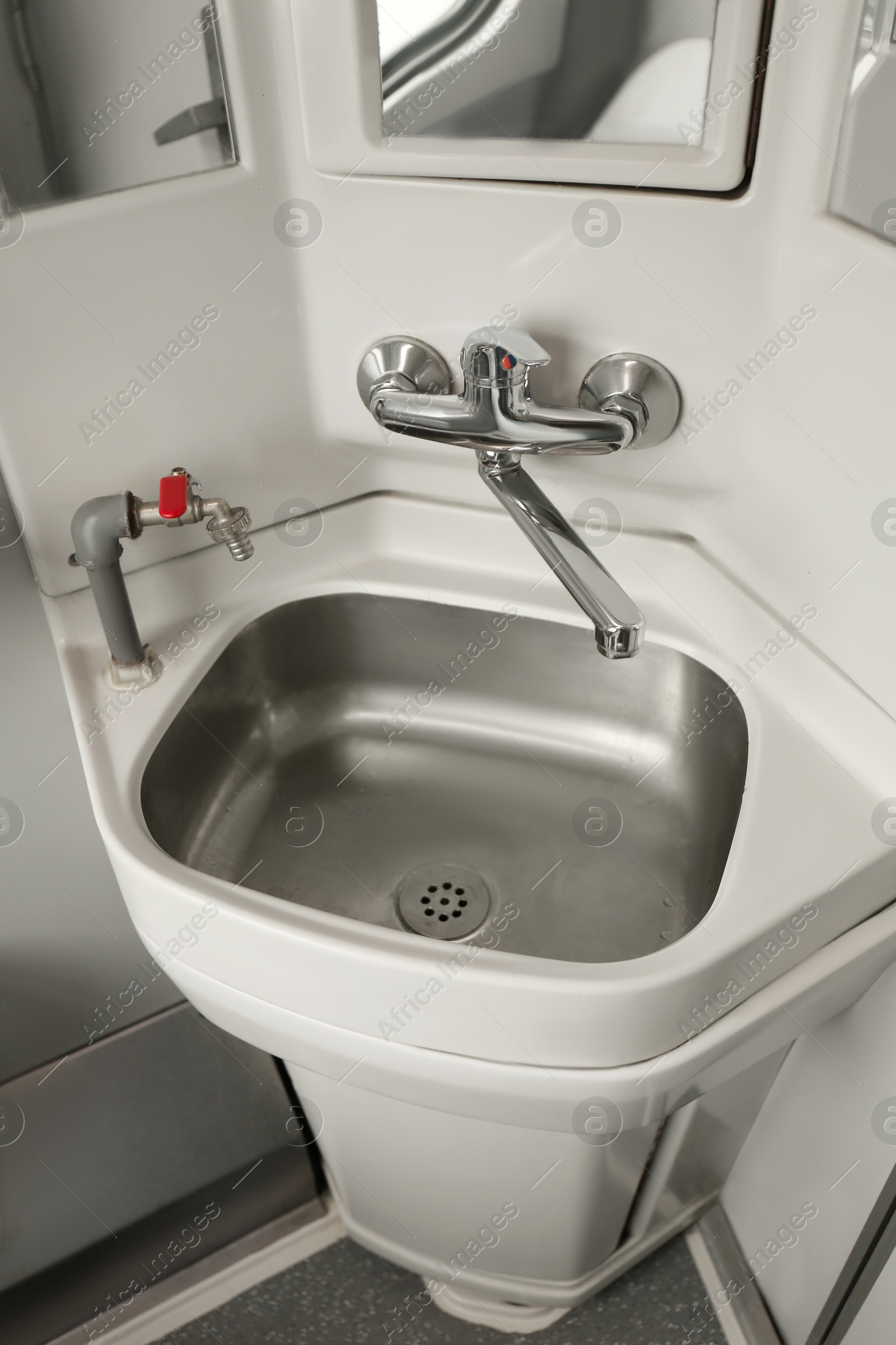 Photo of Stainless steel washbasin in train car restroom