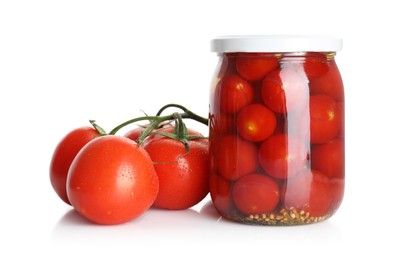 Photo of Tasty pickled tomatoes in jar and vegetable isolated on white