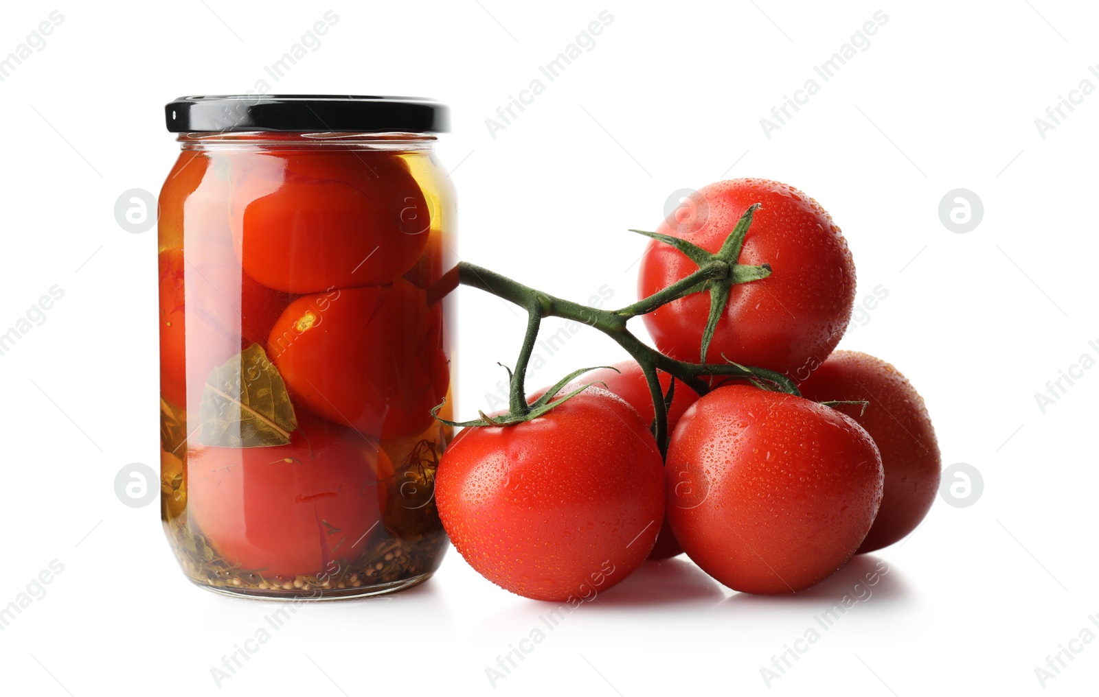 Photo of Tasty pickled tomatoes in jar and vegetable isolated on white