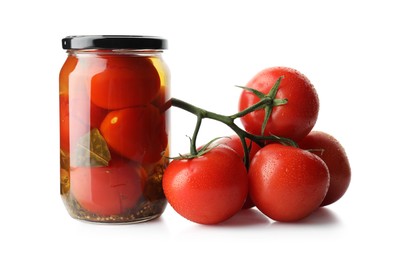 Photo of Tasty pickled tomatoes in jar and vegetable isolated on white