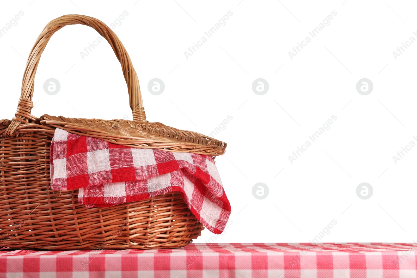 Photo of One picnic basket with napkin on table against white background. Space for text