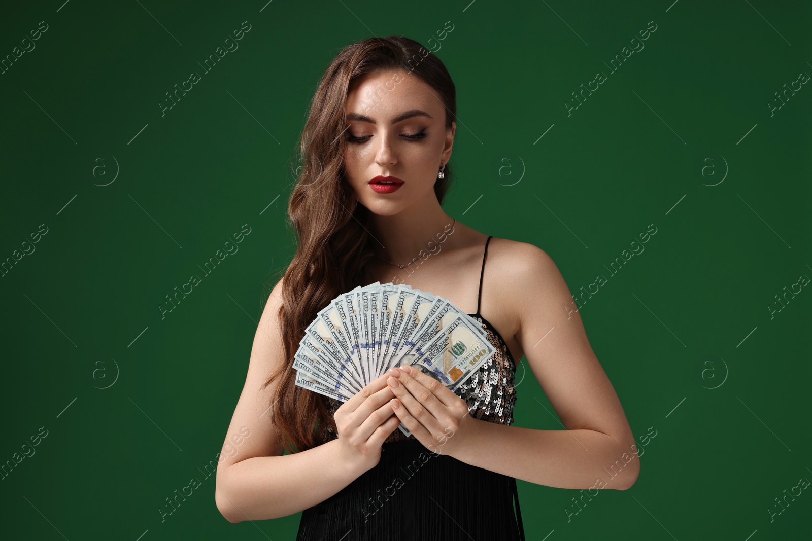 Photo of Charming woman with dollar banknotes on green background
