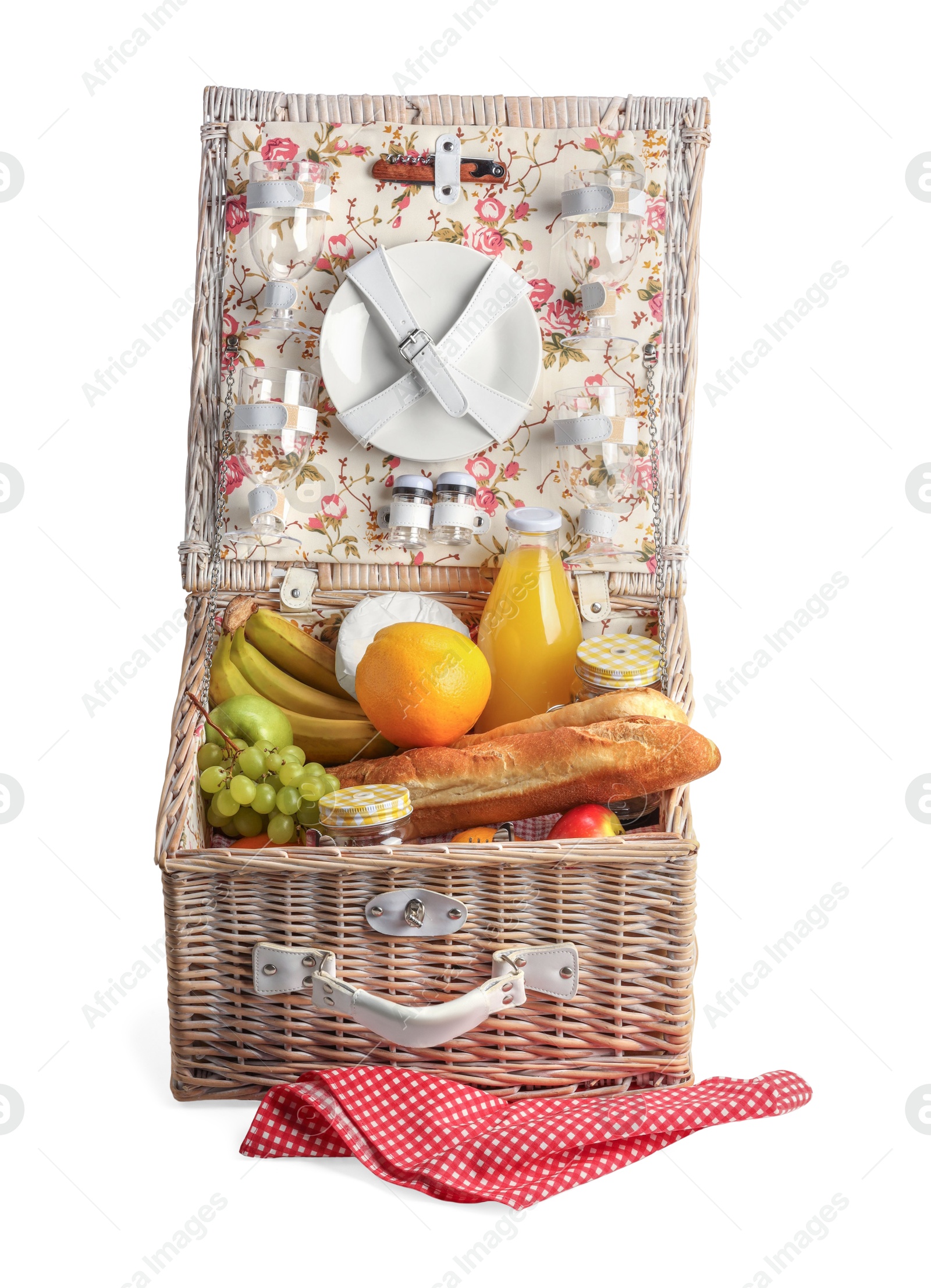 Photo of Picnic basket with tableware, food and drink isolated on white