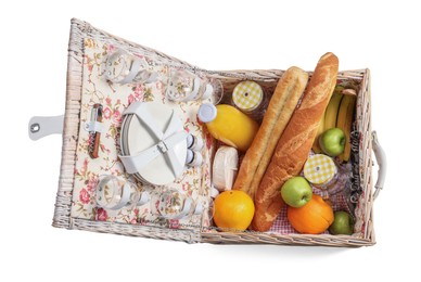 Photo of Picnic basket with tableware, food and drink isolated on white, top view