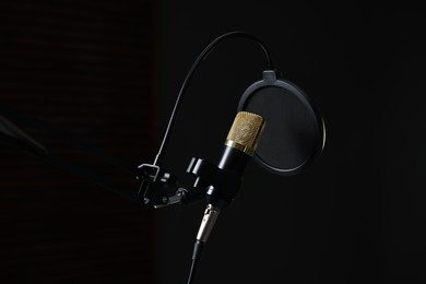 Photo of Stand with microphone and pop filter in record studio