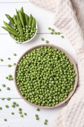 Photo of Fresh green peas and pods on white wooden table, flat lay