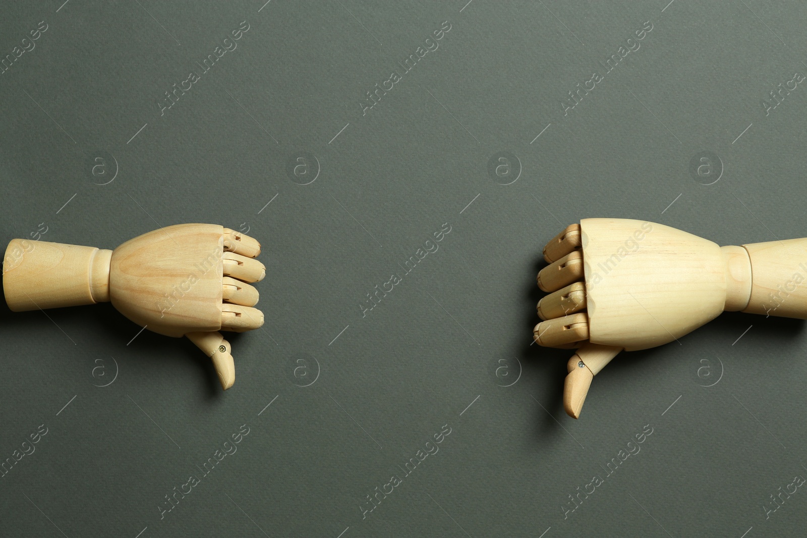 Photo of Wooden mannequin hands on grey background, flat lay