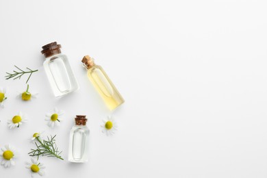 Photo of Aromatherapy. Essential oils and chamomiles on white background, flat lay. Space for text