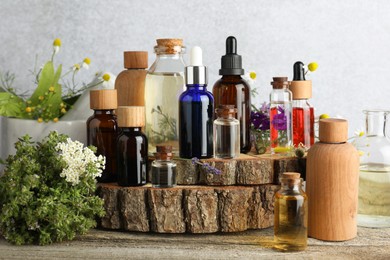 Photo of Aromatherapy. Different essential oils and flowers on wooden table